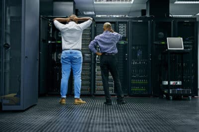 IT engineers checking on server equipment in data center
