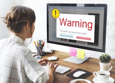 woman working on her computer and clicked on a link with a virus